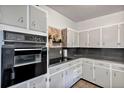 This kitchen shows lots of cabinet space, a built-in oven, and a cooktop in a clean, vintage design at 112 E Coleman Cir, Sanford, FL 32773