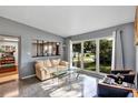 Bright living room featuring a large window with views of the outdoors and stylish furnishings at 112 E Coleman Cir, Sanford, FL 32773