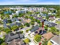 Aerial view of the property showcasing its location within a community with lakes and residential buildings at 13034 Royal Fern Dr, Orlando, FL 32828