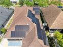 Close-up of a roof with solar panels, highlighting the home's energy-efficient features at 13034 Royal Fern Dr, Orlando, FL 32828