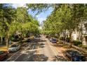A tree-lined street view with cars parked along the sides at 1316 Lake Baldwin Ln, Orlando, FL 32814