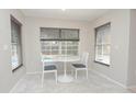 Cozy breakfast nook with views of the pool, complemented by stylish lighting and decor at 14433 Huntingfield Dr, Orlando, FL 32824