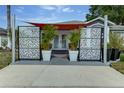 Inviting front entrance with decorative screens, potted plants, and a covered walkway to the front door at 1448 Lambert St, Deltona, FL 32725