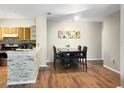 Bright dining area with wood-style floors and a decorative stone-accented breakfast bar at 1475 Lake Shadow Cir # 6205, Maitland, FL 32751