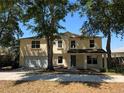 Charming two-story home featuring an attached two-car garage and mature landscaping at 2018 Knollcrest Dr, Clermont, FL 34711