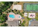 Overhead view of sparkling pool, tennis court, and lounging area at residential community at 2028 Royal Bay Blvd # 85, Kissimmee, FL 34746