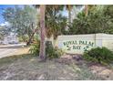 Royal Palm Bay community sign surrounded by lush greenery and mature trees at 2028 Royal Bay Blvd # 85, Kissimmee, FL 34746
