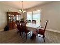 Formal dining area with a large dining table, china cabinet, and sliding glass doors to the outdoor patio at 2445 Verde View Dr, Apopka, FL 32703