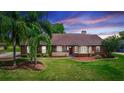 Charming single-story home with a well-maintained lawn and mature palm trees at 2621 Ardon Ave, Orlando, FL 32833
