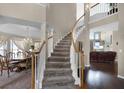 Grand foyer showcases a curved staircase, dining room, and living area with hardwood floors at 3033 Zaharias Dr, Orlando, FL 32837