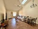 Bright living room with vaulted ceilings, skylight, and cozy seating area at 318 Douglas Way # 87, Winter Garden, FL 34787
