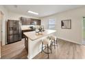 Stylish kitchen featuring stainless steel appliances, granite countertops, and a breakfast bar with seating at 3666 Maidencain St, Clermont, FL 34714