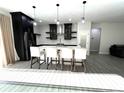 Modern kitchen features a spacious island with seating, sleek black cabinets, and stainless steel appliances at 3764 Rachel St, Apopka, FL 32703
