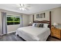 Cozy bedroom with a four-poster bed, soft lighting, and a serene view of the outdoors at 381 Red Mulberry Ct, Longwood, FL 32779