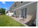 Cozy backyard with a small patio, green grass, and privacy fencing at 4951 Alita Ter, St Cloud, FL 34769