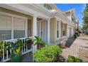 Charming townhouse entrance featuring a welcoming white door, plants and well-maintained landscaping at 4951 Alita Ter, St Cloud, FL 34769