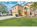 Lovely two-story home with attached garage, well-kept lawn, and tropical landscaping at 5051 Silver Thistle Ln, St Cloud, FL 34772