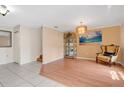 Bright living room boasting tile and wood flooring, an elegant chandelier, and staircase at 5051 Silver Thistle Ln, St Cloud, FL 34772