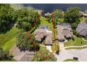 Aerial view of a lakeside home, showcasing a pool, dock, and mature trees around the perimeter at 5479 Baytowne Pl, Oviedo, FL 32765