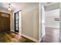 Inviting entryway with a stylish front door, wood flooring, and a glimpse into the rest of the home at 725 Laurel Way, Casselberry, FL 32707