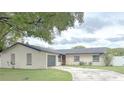 Charming single-story home with a well-maintained lawn and a circular driveway at 725 Laurel Way, Casselberry, FL 32707