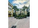 Inviting courtyard view featuring a fountain, landscaped greenery, swaying palm trees, and surrounding buildings at 860 N Orange Ave # 460, Orlando, FL 32801