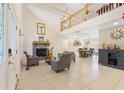 Open-concept living room featuring a fireplace, high ceilings, and smooth transition into the dining area at 5208 Oakdale Rd, Haines City, FL 33844