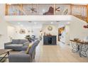Bright living room with a high ceiling, staircase, and open floor plan seamlessly flowing into the kitchen at 5208 Oakdale Rd, Haines City, FL 33844