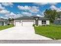 This single Gathering home features a three-car garage, manicured lawn, and classic design at 12950 Sw 38Th Cir, Ocala, FL 34473