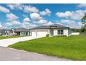 A well-manicured lawn leads up to this single Gathering home with a three-car garage at 12950 Sw 38Th Cir, Ocala, FL 34473