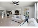 Bright, open-concept living room with tile floors flows into kitchen, creating a welcoming space with ample natural light at 256 Whirlaway Dr, Davenport, FL 33837