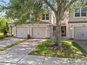 Charming townhome with attached garages and well-maintained landscaping showcasing its inviting curb appeal at 8316 Quimby Cir, Davenport, FL 33896