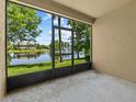 Relaxing screened patio overlooking a serene lake with a beautiful fountain view and lush greenery at 8316 Quimby Cir, Davenport, FL 33896