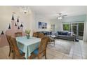 Cozy living room and dining area featuring tile floors, a chandelier, and a fun Disney castle mural at 8487 Crystal Cove Loop, Kissimmee, FL 34747