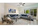 Comfortable living room with screened-in porch access, plush seating, and natural light at 8487 Crystal Cove Loop, Kissimmee, FL 34747