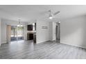 Spacious living room featuring wood-look flooring, a ceiling fan, and sliding glass doors to the patio at 10105 Crozier Ct, Orlando, FL 32817