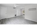 Spacious living room with ceiling fan, gray plank flooring, and neutral walls at 10105 Crozier Ct, Orlando, FL 32817