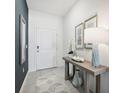 Inviting entryway featuring tile flooring, modern decor, and a stylish console table with decorative accents at 10132 Huntingnet Way, Leesburg, FL 34748