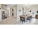 Bright dining room featuring a modern light fixture, a wooden table and seating for six, and stylish decor at 1028 Sadie Ridge Rd, Clermont, FL 34715