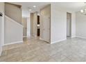 Open-concept living room with neutral paint, tile floors, and a view of the staircase at 1028 Sadie Ridge Rd, Clermont, FL 34715