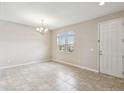 Living room featuring tile floors, neutral walls, chandelier and natural light at 1028 Sadie Ridge Rd, Clermont, FL 34715