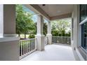Covered front porch with white railing and supporting columns creating inviting outdoor space at 1052 Avila Ln, Orlando, FL 32803