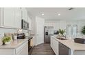 A modern kitchen featuring stainless steel appliances, quartz countertops, and sleek cabinetry at 1078 Clay Blvd, Tavares, FL 32778