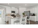 Modern kitchen with white cabinets, stainless steel appliances, and a large island with seating at 1078 Clay Blvd, Tavares, FL 32778