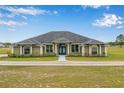 Charming one-story home featuring lush landscaping and a welcoming entrance at 11400 Lovers Ln, Winter Garden, FL 34787