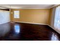 Spacious living room featuring shiny hardwood floors and a bright window at 12101 Kendra Ct, Orlando, FL 32824