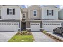 Charming townhomes featuring brick driveways, manicured lawns, and attached one-car garages at 1263 Stockwell Ave, St Cloud, FL 34771