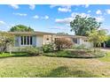 Charming single-story home featuring blue shutters and a beautifully landscaped front yard at 1440 Roosevelt St, Orlando, FL 32804