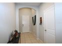 Inviting home entryway with tile flooring, an arched doorway, and neutral wall colors at 146 Loblolly Ln, Davenport, FL 33837