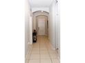 Hallway with neutral-colored walls and tile flooring that offers seamless transition and easy maintenance at 146 Loblolly Ln, Davenport, FL 33837